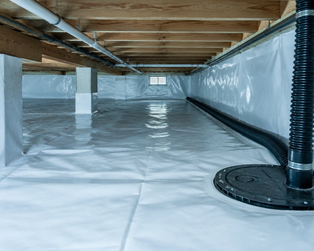 Drainage system and sump installed in a crawl space during a waterproofing project